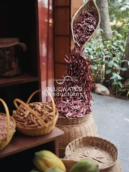 A creative installation of dried red chilies pouring out of a basket.