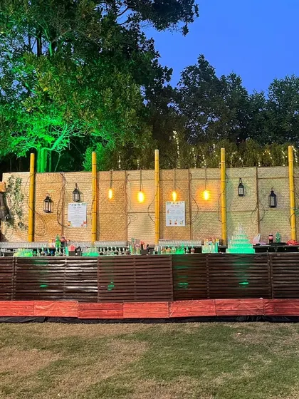 For a natural, earthy theme, we offer this expansive rustic bar setup. Its wooden slat design and warm lighting blend seamlessly into garden or palace ground settings.