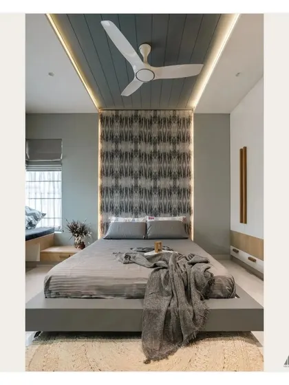 This perspective shows the full length of the bedroom, highlighting the floating bed design and the striking patterned wallpaper that serves as a headboard, framed by subtle LED strip lighting.