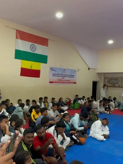 The team gathered at the academy, reflecting on their victories. The Indian and Karnataka flags in the background symbolize who we represent with pride.