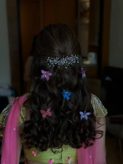 A final shot of the half-updo with butterflies, a fun and memorable choice for a Mehndi party.