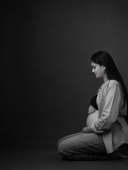 The same intimate portrait, presented in timeless black and white. This version removes all distractions, emphasizing the emotion, form, and beautiful play of light and shadow.