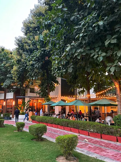 A wide view of the cafe patio and grounds, showcasing the ample space available for guests at a private evening event.