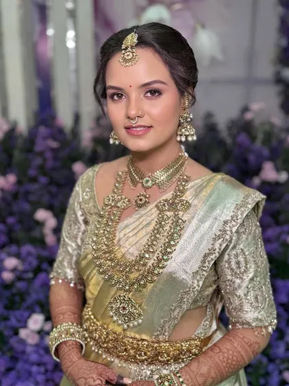 A dreamy and ethereal Muhurtham look. Even with no sleep after her reception, this bride's skin is luminous and fresh, paired with timeless temple jewellery for a truly royal South Indian bridal style.