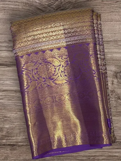 A classic purple Kanchi silk saree with a heavy gold brocade border and pallu.