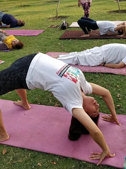 Students fully expressing Chakrasana (Wheel Pose) during our International Yoga Day celebration in the park. It's inspiring to see such dedication and flexibility across our community.