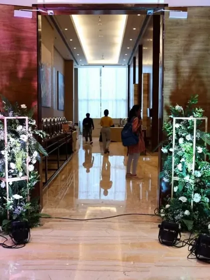The entrance to the Fairfield by Marriott ballroom, framed with our custom floral stands and uplighting. This setup creates an elegant transition for guests as they enter the main event space for an evening gala.