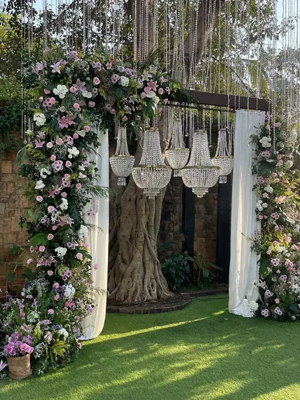 An enchanting entrance arch combining lush pastel florals with the timeless elegance of crystal chandeliers. This design creates a grand and magical welcome for your guests.