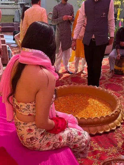 A back view of my custom Haldi outfit. The floral print and backless design with a simple pink dupatta was a comfortable and stylish choice for the poolside event.