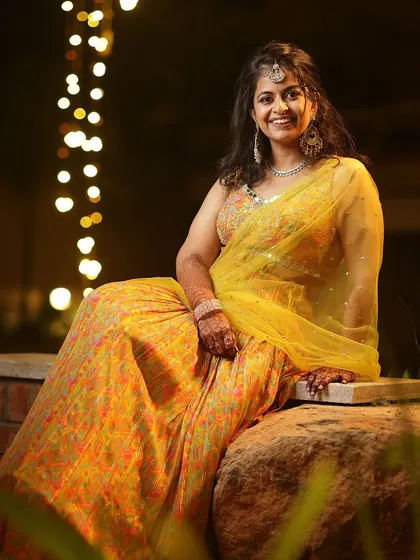 A beautiful portrait of a guest at a mehendi function, her hands adorned with a lovely henna stain.