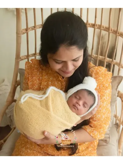 There's nothing like a cuddle with mum. This photo captures the warm, secure feeling of a baby being held in their mother's arms.
