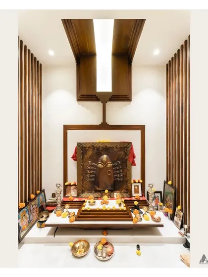 The fully adorned Pooja mandir. We designed this sacred space to be harmonious and Vastu-compliant, using natural materials and focused lighting to create a serene atmosphere for worship.