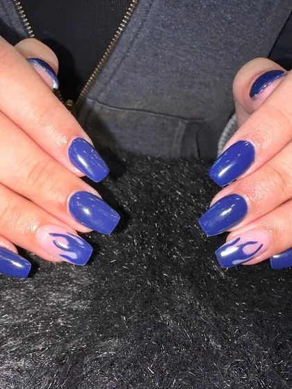 Bringing the heat with this blue flame nail art. I painted delicate flames on the accent nails for a cool, edgy touch to this solid blue manicure. This is a great way to add a bit of attitude to your set.