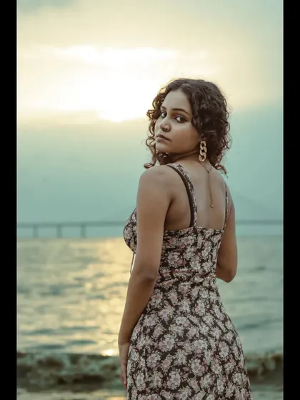 A portrait from our sunset shoot near the Bandra-Worli Sea Link. The warm tones of the setting sun and the model's direct gaze create a powerful and moody image.