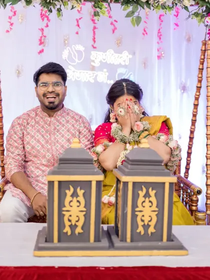A candid moment of laughter and shyness during a baby shower game. The mother-to-be covers her face playfully while her partner laughs, capturing the genuine, unscripted joy that makes these events so special.