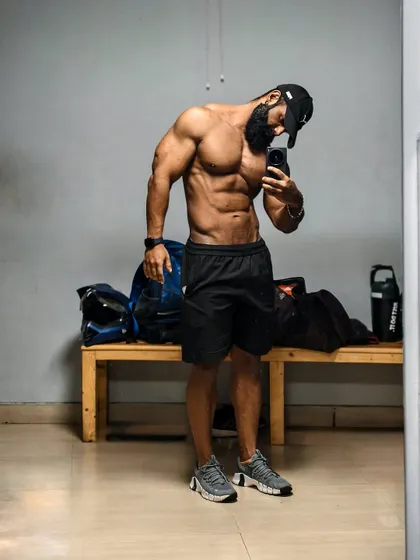 Another angle of a locker room selfie, showing the physique from a slightly different perspective. Consistency is key.