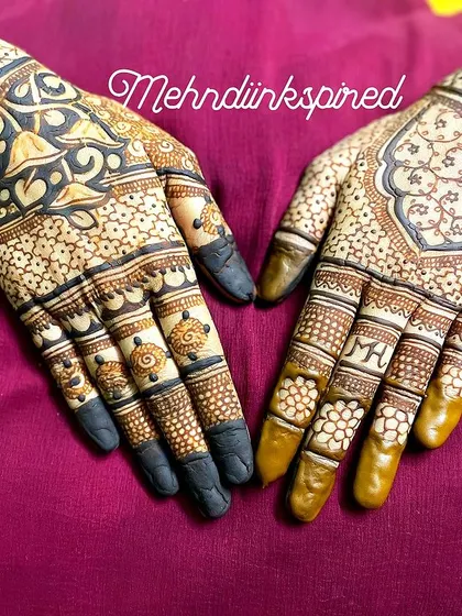 The back of the hands deserves just as much attention. This intricate design features a central mandala and detailed patterns covering the fingers, with the couple's initials hidden within.