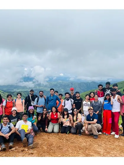 A large, happy group photo at the summit of Netravati peak. Conquering the trail together makes the view even sweeter.