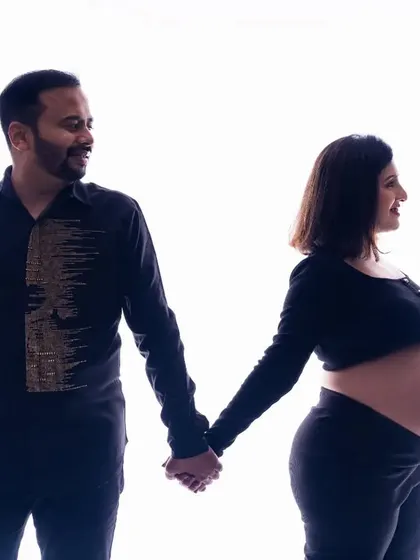 Holding hands and looking towards the future. This silhouette shot captures the partnership and shared excitement of expecting parents in a simple yet profound way.