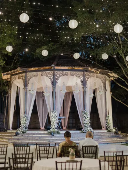 A wide view of the pastel Sangeet, with guests enjoying the beautiful setup under the stars.