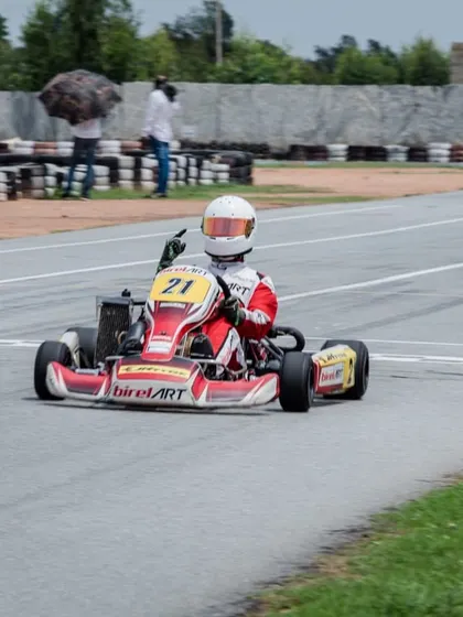 A victory gesture from Mihir Avalakki as he finishes another race in P1. This confidence comes from having a perfectly prepared kart and a winning strategy.