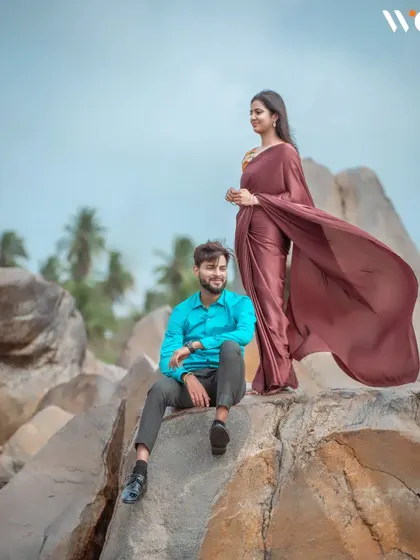 A beautifully composed pre-wedding shot on a rocky outcrop. The wind catching the bride's saree adds a touch of elegance and movement to this serene portrait.