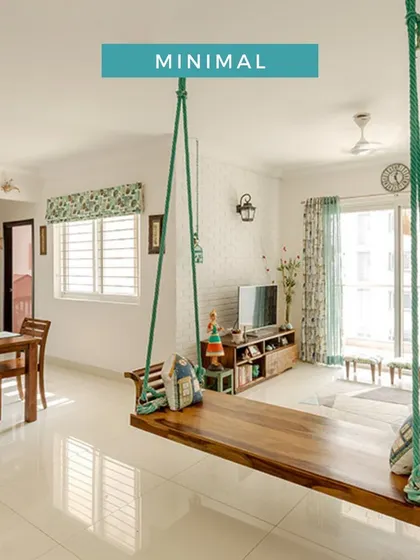 A minimal living room featuring a large wooden swing as the centerpiece, simple wooden furniture, and a light, airy feel.