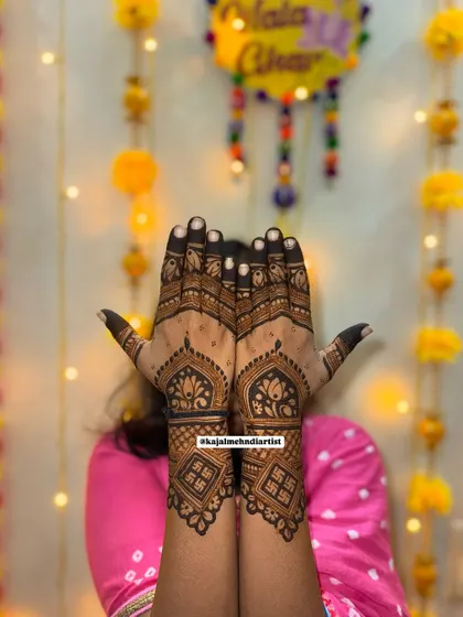 A festive design with auspicious Swastik symbols for blessings. The background of marigold flowers and lights makes this henna perfect for Diwali or any puja.