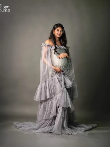 The dramatic sweep of the grey tulle gown is on full display in this portrait. It's a perfect example of how I use wardrobe to create visually impactful images.