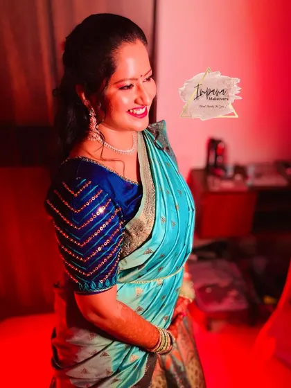 The bride's joyful laugh captured during her Mehendi. Her hairstyle is a chic half-updo, perfect for the occasion.