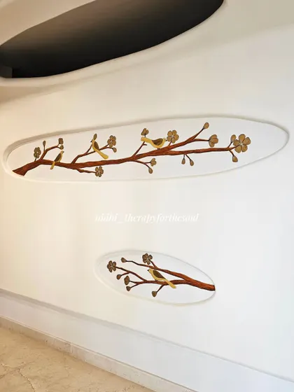 Another view of the birds on branches mural, showing how the two separate pieces create a cohesive and balanced design on the wall.