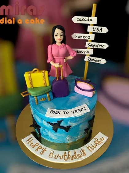 A cake for someone born to travel. This design features a figurine with luggage and a signpost pointing to destinations around the world, capturing the spirit of a true globetrotter.