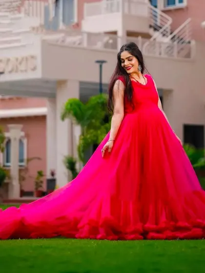 This hot pink maternity gown with a ruffled train makes a bold statement. It's an excellent rental choice for outdoor shoots where you want to stand out.