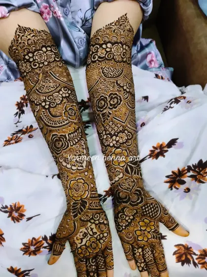 A close-up of the arm portion of a bridal design, showing the mix of floral and geometric elements.