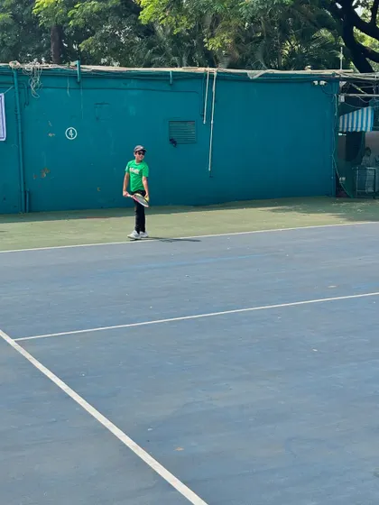 A young competitor stands ready on the court during the Inter School Tennis Tournament, showcasing the focus we instill in our players.
