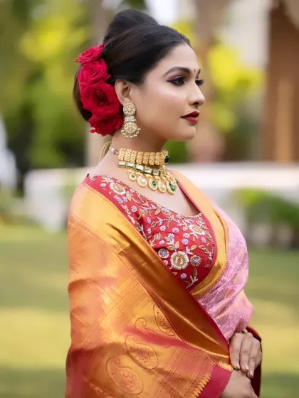 A side profile of the reception look, highlighting the elegant hairstyle and the perfect blending of the makeup.