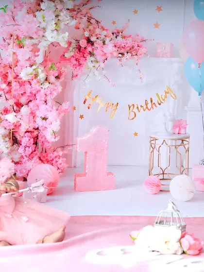 Holding a magic wand, this birthday girl is ready to make a wish. The wide shot shows the full, enchanting pink floral setup I created in the studio.