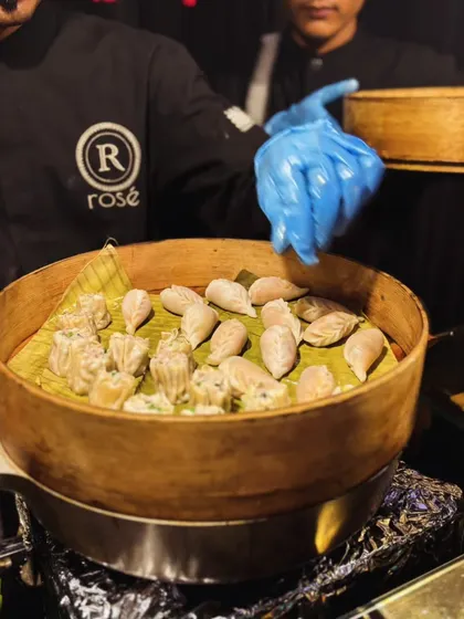 Our chef presents a steamer basket filled with freshly prepared dim sum. We ensure our live stations are not only about great taste but also about showcasing the craft behind each dish.