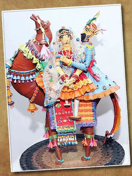 An incredibly detailed 3D artwork of a Rajasthani couple on a camel, made entirely from quilled paper. This shows the advanced possibilities of the quilling technique.
