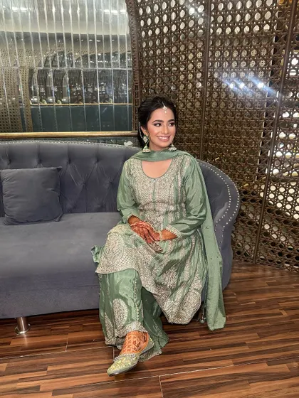 The client looks happy and beautiful, ready for the Mehndi festivities. The makeup is designed to be long-lasting and comfortable.