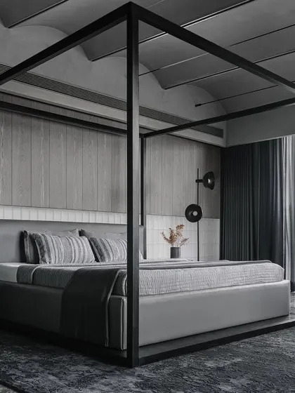 This large four-poster bed was designed to anchor the voluminous master bedroom of the Vaulted Haus. Its strong metal frame defines a room within a room, creating a sense of intimacy while complementing the architectural vaults in the ceiling.