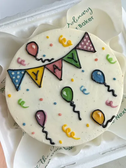 Yay for celebrations. This mini cake is all about party vibes, with colorful bunting, balloons, and confetti piped on top. It’s a celebration in a box.