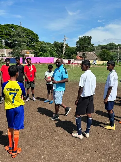 A coach strategizes with his team during our event at KGF. These moments of mentorship are crucial for player development.