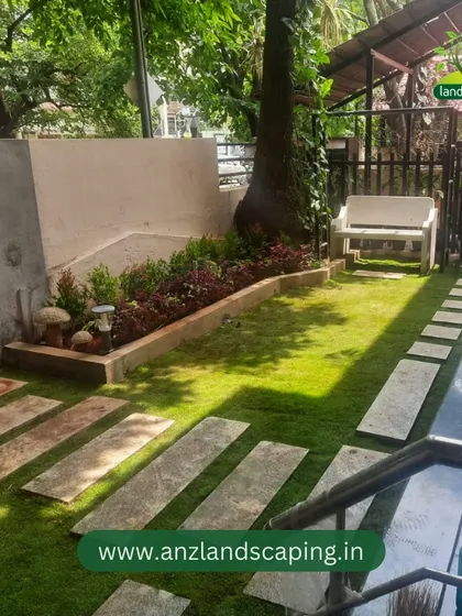 A high-angle view of the completed front yard, emphasizing the geometric layout of the stone pavers and the neat, defined edges of the lawn.