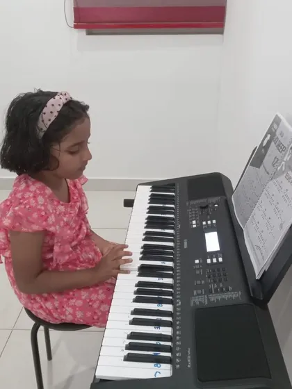Another shot of a young girl practicing keyboard. We have many young learners in our community.