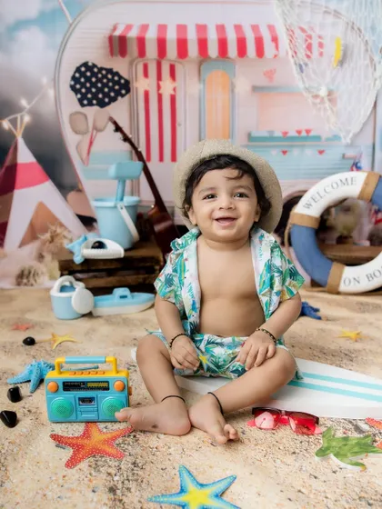 This little dude is ready to hit the waves. The beach-themed photoshoot is great for boys and girls.