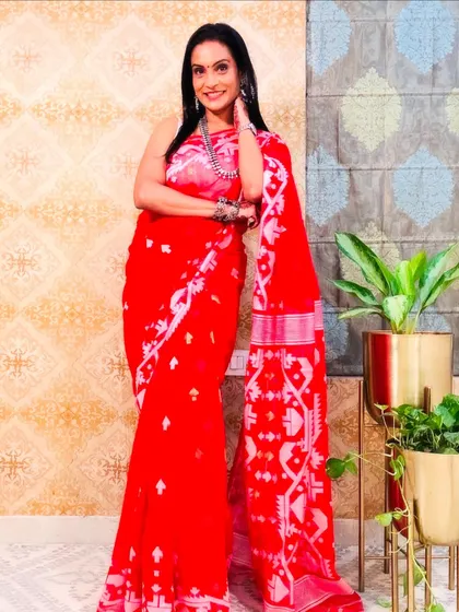 This red Jamdani saree is a bold and beautiful choice. The intricate white weaving stands out against the red background.