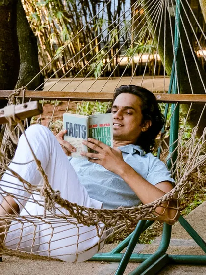 A guest enjoys a good book while relaxing in a hammock, the perfect way to unplug and recharge.