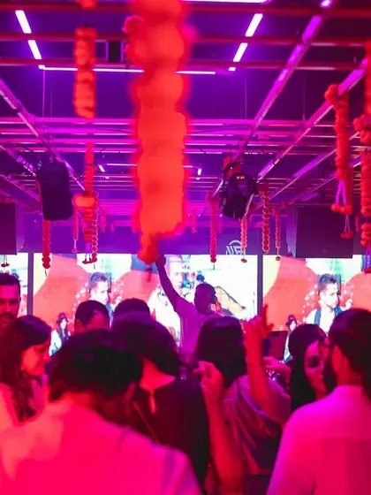 The view from the back of the dance floor at Gawky Goose, with festive decorations and a great crowd enjoying the music.