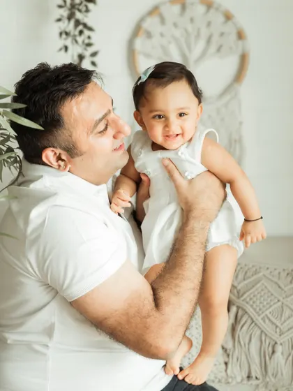 A close-up of a father and daughter sharing a happy moment, highlighting their joyful connection.